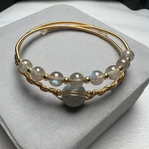 Detailed macro view of 14K gold-filled wire-wrapped bracelet with moonstone beads