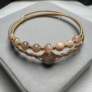 Detailed macro view of handmade 14K gold-filled wire wrapped bangle with moonstone beads