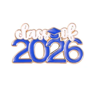 Detail of 2026 graduation cap enamel pin with Class of 2026 lettering and gold trim