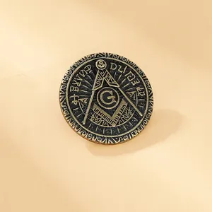 Macro shot of vintage bronze Masonic emblem pin with Eye of Providence and square symbol