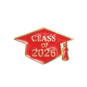 Detail of Class of 2026 graduation cap pin with red enamel and gold metallic plating