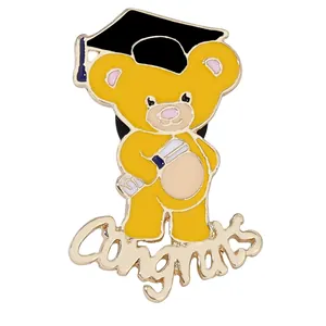 Detail of enamel graduation pin featuring a yellow bear with cap and Congrats text