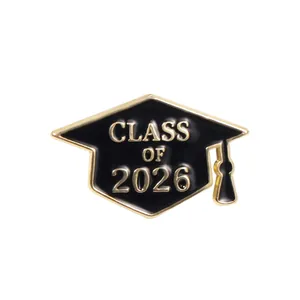Detailed view of 2026 graduation cap enamel pin with golden tassel and black finish