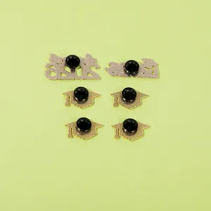 Detail view of the back of 2024 graduation pins with gold plating and rubber clutches