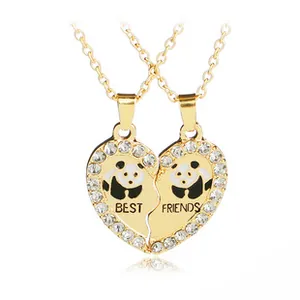 Close-up of gold Best Friends heart pendant with panda motif and zircon stones