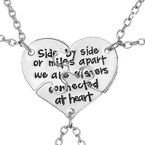 Three-piece silver heart puzzle necklace set with engraved sisterhood message for friends