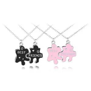 Detail of interlocking puzzle piece friendship necklaces with Best Friends engraving