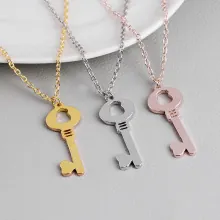 Detailed trio of key-shaped star necklaces in gold, silver and rose gold finishes