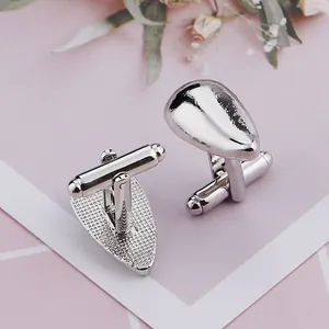 Detailed view of silver teardrop cufflinks showing polished front and textured back