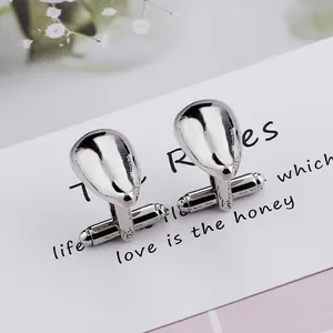 Polished silver teardrop cufflinks for men featuring a classic T-shaped closure