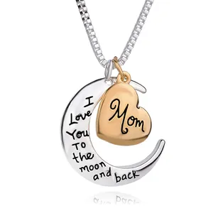 Macro detail of silver crescent moon and gold heart pendant engraved for Mother's Day