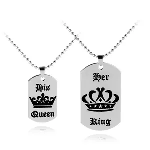 Detail of Her King and His Queen dog tag pendant necklaces with crown engravings
