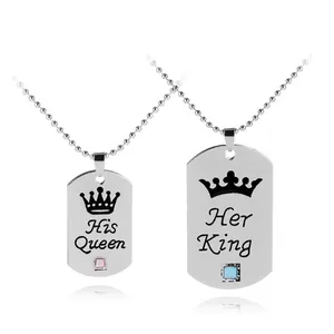 Detail of His Queen and Her King dog tag pendants with crown engraving and inset crystals