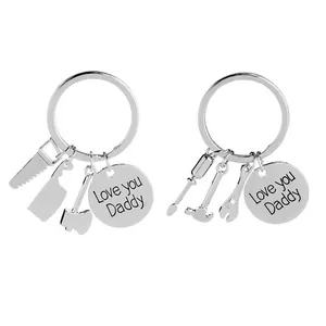 Detail of silver Daddy keychain set with Love you Daddy engraving and tool charms