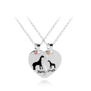 Detail of silver heart pendants with Mama and Giraffe engraving and colored gems