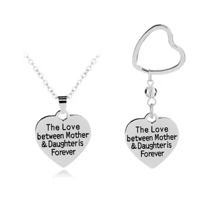 Detail of silver heart necklace and keychain set with Mother & Daughter forever engraving