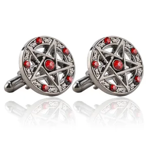Dettagli dei gemelli con pentagramma con strass rossi e finitura argento antico