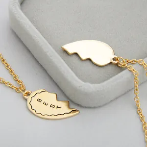 Macro shot of gold-plated BEST FRIENDS heart puzzle necklace with engraved detail