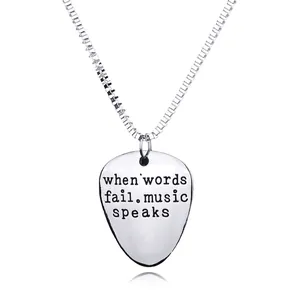 Polished guitar pick necklace engraved with 'When words fail music speaks' on box chain