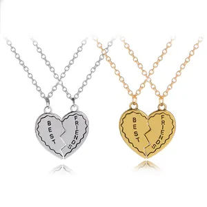 Golden and silver split heart necklaces engraved with Best Friends on white background