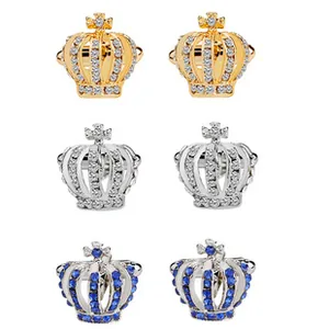 Close-up of royal crown cufflinks in gold, silver, and deep blue gemstone finishes