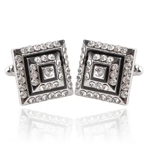 Macro shot of silver square cufflinks with rhinestones and black enamel inlay details