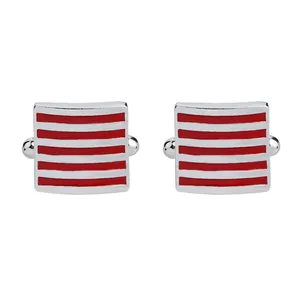 Macro view of square silver cufflinks featuring five parallel red horizontal stripes