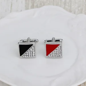 Detail of square cufflinks with red and black enamel patterns and crystal accents
