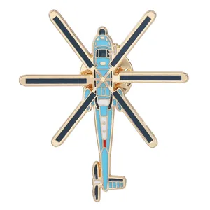 Detailed top view of a helicopter enamel pin with blue finish and golden base