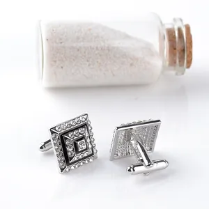 Detail of square cufflinks with black enamel inlay and centered sparkling rhinestones