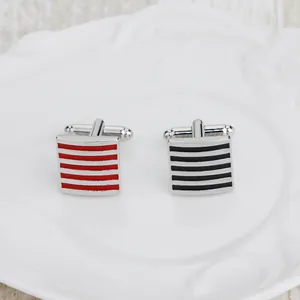 Detailed view of silver square cufflinks with enamel horizontal stripes in red and black