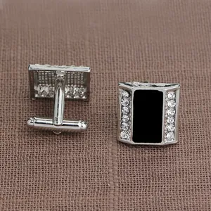Detailed macro of square silver cufflinks with black inlay and sparkling rhinestones
