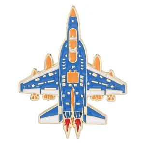 Detail of fighter jet enamel pin featuring blue, white and orange colors with gold edges