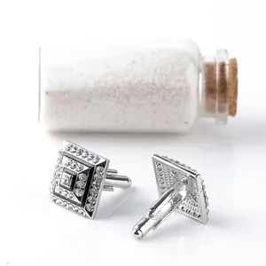 Macro detail of square cufflinks with black enamel and sparkling rhinestones