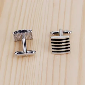 Detailed view of silver square cufflinks with black enamel stripes and T-bar closure