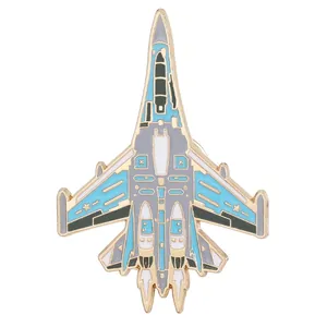 Detailed close-up of a blue and grey enamel fighter jet brooch with gold plating
