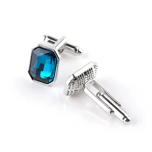 Polished silver cufflinks featuring rectangular deep blue crystals with toggle closures