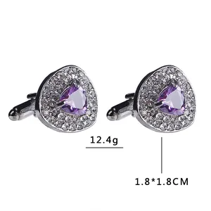 Detail of silver heart cufflinks with purple triangle crystal and micro-pave white stones