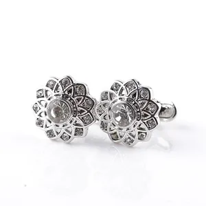 Detail of luxury silver floral cufflinks with brilliant clear rhinestones and mirror finish