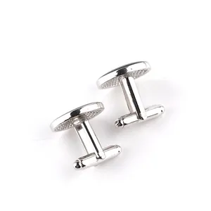 Detailed close-up of silver and black round men's cufflinks with polished T-bar structure