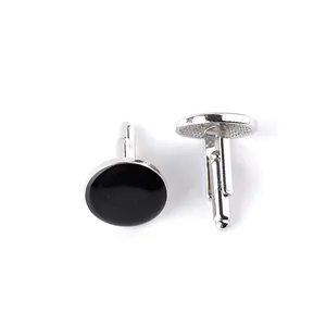 Close-up of elegant black enamel round cufflinks with a polished silver base for men