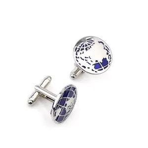 Detailed close-up of round silver cufflinks with blue globe map design for dress shirts