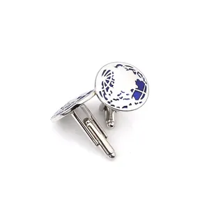 Detail view of round silver cufflinks featuring blue enamel world map design for men