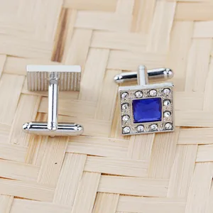 Macro view of square silver cufflinks with dark blue crystal and sparkling rhinestones