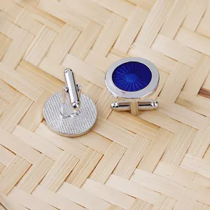 Detailed close-up of blue sunray pattern enamel cufflinks with silver alloy base