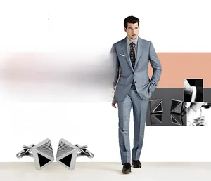 Detail view of square cufflink with black triangular inlay and geometric textures
