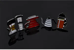Detailed view of coffee brewing equipment enamel pins set on black reflective surface