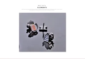 Detailed view of coffee brewing enamel pins with reflective shadows on a grey surface