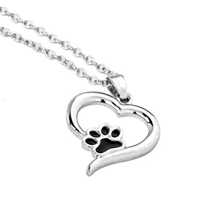 Detailed view of silver heart pendant with black paw print on a thin O-link chain