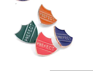 Set of four colorful shield enamel pins featuring PREFECT text in red, blue, green, and orange